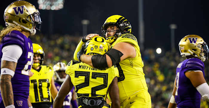 Oregon Ducks offensive lineman Jackson Powers-Johnson hugs running back Noah Whittington after a touchdown against the Washington huskies.